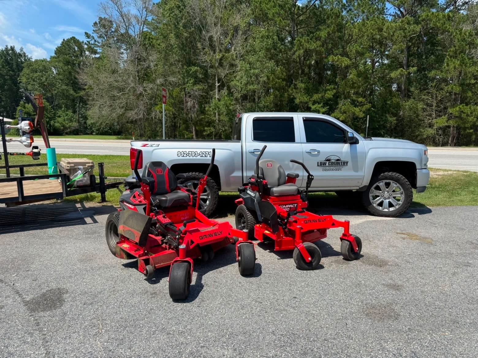 Lowcountry Lawn & Landscape truck with commercial Gravely zero-turn mowers